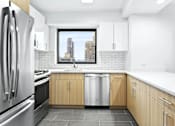 Thumbnail 27 of 56 - A modern kitchen with wooden cabinets and a stainless steel refrigerator.