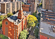 Thumbnail 50 of 56 - A cityscape with a prominent red church in the foreground.