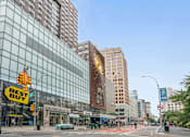 Thumbnail 7 of 9 - A city street with Best Buy and Acura dealerships.