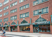 Thumbnail 8 of 9 - A Chipotle restaurant is located in a brick building.