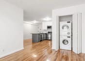 Thumbnail 4 of 11 - A white laundry room with a washer and dryer in it.