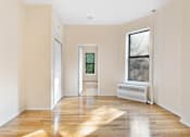 Thumbnail 11 of 18 - A room with a wooden floor and a window with a white frame.