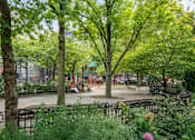 Thumbnail 18 of 18 - A park with trees and benches.
