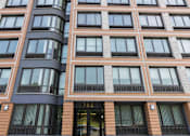 Thumbnail 19 of 22 - A tall building with the number 702 on the door.