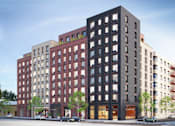 Thumbnail 21 of 22 - A large multi-story building with a red brick facade.