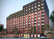 Thumbnail 22 of 22 - A red brick building with a black top and a green roof.