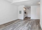 Thumbnail 3 of 22 - A room with wooden flooring and white walls.