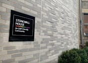 Thumbnail 9 of 9 - A sign on a building that says Stonewall House an LGBT friendly community.