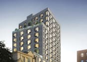 Thumbnail 2 of 9 - A modern building with a green roof and a group of people standing in front of it.