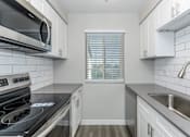 Thumbnail 10 of 11 - Modern Kitchen at Jolt Apartments, Las Vegas, NV