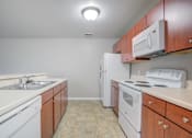 Thumbnail 17 of 20 - Kitchen with Wooden Cabinets at PALMETTO RIDGE Apartments, TITUSVILLE