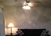Thumbnail 24 of 28 - A room with a light on the wall and a curtain hanging.