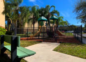 Thumbnail 17 of 20 - Portofino Apartments bench seating next to playground at Portofino, Palm Springs, Florida