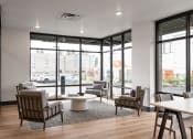 Thumbnail 7 of 22 - a lounge area with chairs and a coffee table in front of a large window at QUINN BY VINTAGE, Shoreline, WA, 98155