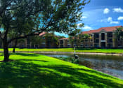 Thumbnail 4 of 15 - Exterior with palm trees and lake at Renaissance, West Palm Beach, FL