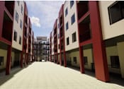 Thumbnail 5 of 7 - A long corridor with red and white buildings on either side at Vintage at Lockwood Apartments, Oxnard