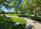 Thumbnail 2 of 21 - Nicely landscaped grounds with bench seating at DOVER WOODS SENIOR APARTMENTS, California