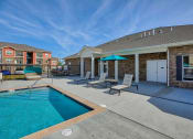 Thumbnail 40 of 48 - Pool with patio furniture at Salish Flats APARTMENTS, Airway Heights, WA