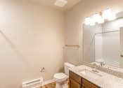 Thumbnail 13 of 48 - bathroom with sink, mirror, and toilet at Salish Flats APARTMENTS, Airway Heights, WA