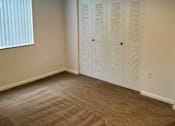 Thumbnail 14 of 21 - Bedroom with carpeting and ceiling fan at San Marco Apartments, Ormond Beach, Florida