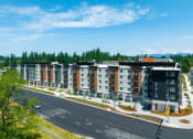 Thumbnail 3 of 27 - an aerial view of a row of apartment buildings with a road in the foreground at STATION BY VINTAGE, COVINGTON, WA