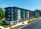 Thumbnail 2 of 27 - a rendering of a large apartment building with a street in front of it at STATION BY VINTAGE, COVINGTON, WA 98042