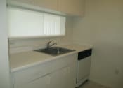 Thumbnail 9 of 18 - Siesta Pointe apartment home kitchen with white appliances and white cabinetry at Siesta Pointe, Florida