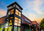 Thumbnail 67 of 81 - the exterior of a building with a sunset in the background