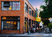 Thumbnail 66 of 81 - people walking down a street in front of a brick building