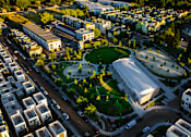 Thumbnail 65 of 81 - an aerial view of a city with buildings and a green park