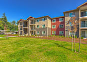 Thumbnail 17 of 26 - Building exterior and green grounds at SOUTH HILL BY VINTAGE, Puyallup, Washington