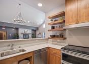 Thumbnail 6 of 12 - Kitchen area with wooden cabinets at South Peak by Vintage, Reno