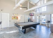 Thumbnail 7 of 19 - Pool table near seating and TV at THE EDGE Apartments, DAVIS, California