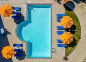 Thumbnail 5 of 19 - Pool with lounge chairs Aerial view at THE EDGE Apartments, California