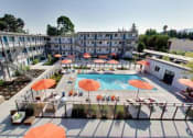 Thumbnail 23 of 26 - The Post Apartments pool area with umbrellas and lounge seating at THE POST Apartments, California, 94523