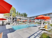 Thumbnail 26 of 26 - pool area with umbrellas and lounge seating at THE POST Apartments, PLEASANT HILL 
