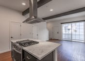 Thumbnail 32 of 41 - a kitchen with an island and stove at THE ANGELINO, Sacramento, CA