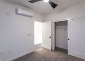 Thumbnail 41 of 41 - a bedroom with a ceiling fan and a closet at THE ANGELINO, Sacramento California