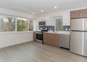 Thumbnail 8 of 33 - a kitchen with stainless steel appliances and a large window THE MOD AT MIDTOWN Apartments, SACRAMENTO