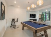 Thumbnail 5 of 33 - a pool table in a living room with a bar and a tv at THE MOD AT MIDTOWN Apartments, SACRAMENTO