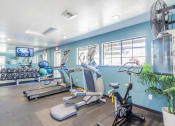 Thumbnail 8 of 19 - Fitness room with cardio and weights at THE EDGE Apartments, California, 95618