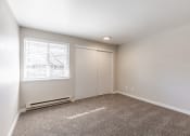 Thumbnail 11 of 31 - 2 BR Apartments in Portland OR - Township Eastside - Empty Bedroom with Wall-to-wall Carpet, Window, and Closet at Township Eastside, Portland