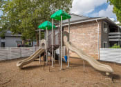 Thumbnail 28 of 31 - Gresham Apartments - Township Eastside - Playground with Climbing Equipment and Slides at Township Eastside, Portland