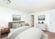 Thumbnail 6 of 31 - Two-Bedroom Apartments in Gresham, OR- Township Eastside- Large Bed with White Dresser and Wall-to-Wall Carpeting at Township Eastside, Portland, 97236