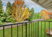 Thumbnail 26 of 28 - Township Sherwood Exterior balcony, lush landscaping, fall foliage at TOWNSHIP SHERWOOD, Sherwood