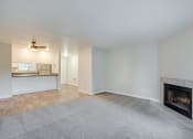 Thumbnail 9 of 46 - Living Room with Plush Carpeting and an Interior Fireplace at TOWNSHIP Apartments, CANBY, Oregon