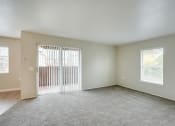 Thumbnail 21 of 46 - Living room with window and patio at TOWNSHIP Apartments, CANBY