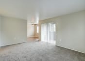 Thumbnail 14 of 46 - Living room with patio doors at TOWNSHIP Apartments, Oregon 97013