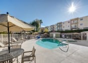 Thumbnail 4 of 15 - Pool With Relaxing Chairs at VINTAGE AT SEVEN HILLS 55+ COMMUNITY, Henderson Nevada