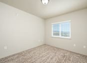 Thumbnail 6 of 32 - Room with carpeted floor and window at Vintage at Laughlin, Laughlin